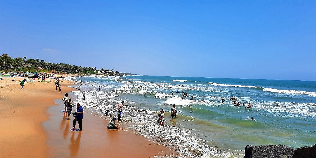 Image of a serene, sunny coastline and historic village.